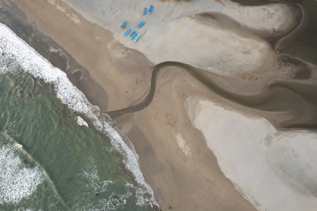 Many blue boats on sea beach above top drone view