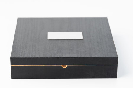 Closed wooden case with metal plate front view isolated on studio backgroundの写真素材
