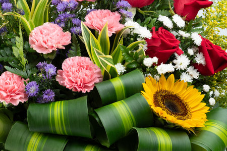 Blossom of colorful flowers in big bouquet with green leavesの写真素材