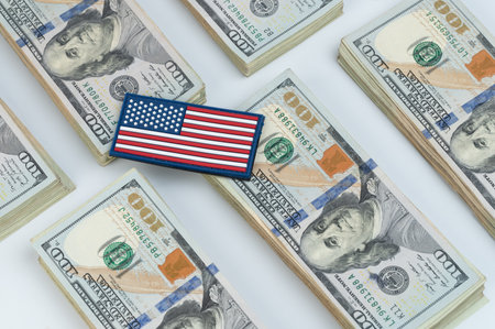 American flag sticker on 100 dollar paper bills backgroundの写真素材