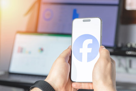 New York, USA - June 6, 2024: Facebook service on smartphone screen in hands close up view on tech...