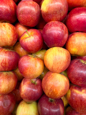 Red and yellow color apples flat background close up viewの写真素材