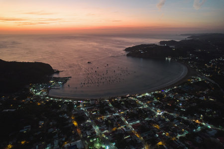 Many small boats in bay at evening dusk light aerial drone viewの写真素材