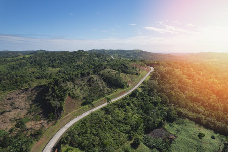 Mountain empty road aerial view with bright sunny day