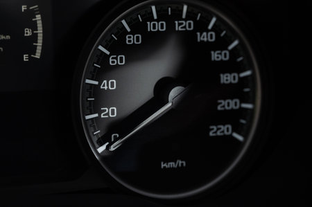 Modern car speedometer on black background close up view