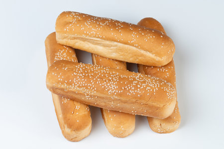 Hotdog brown buns pile with sesame seed isolated on white studio backgroundの写真素材