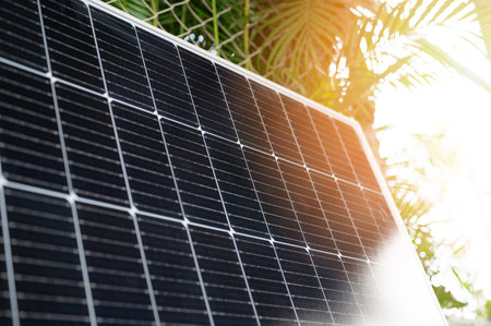 Photovoltaic solar panel on green sunny tropical background close up viewの写真素材