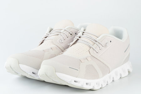 Perspective view on sport light pair shoes isolated on studio backgroundの写真素材