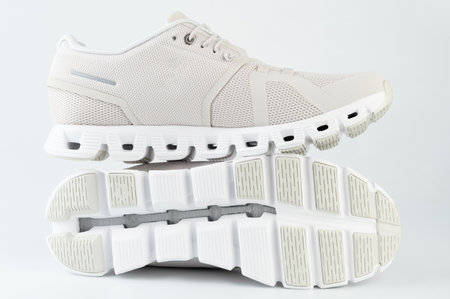 Textile clothing white sport shoes side view with sole isolatedの写真素材