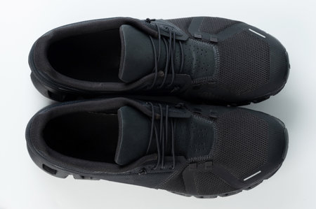New black trainer shoes with laces above top view isolatedの写真素材