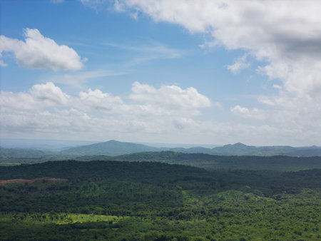 Green hill valley on blue sky with white clouds aerial drone viewの写真素材
