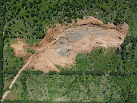 Big mining quarry in green forest above top viewの写真素材