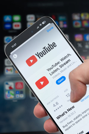 New York, USA - August 5, 2024: Smartphone in hand with Youtube app on screen macro close up view with blur backgroundのeditorial素材