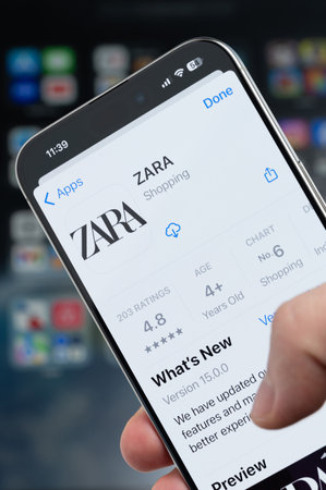 New York, USA - August 5, 2024: Smartphone in hand with Zara app on screen macro close up view with blur backgroundのeditorial素材
