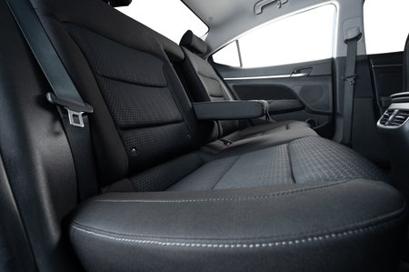 Comfortable grey color car rear sofa with open armrest and isolated windows side view