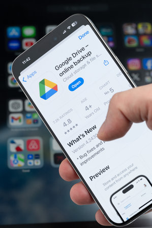 New York, USA - August 5, 2024: Smartphone in hand with Google drive app on screen macro close up view with blur backgroundのeditorial素材