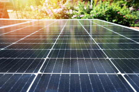Solar energy Technology theme. Clean sun panel on blurred green natural background
