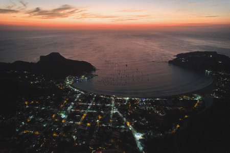 Illuminated streets in tropical city aerial drone viewの写真素材