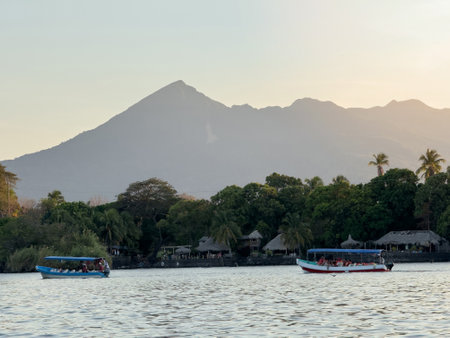 Boats going on tour  to see tropical landscape with volcanoの写真素材