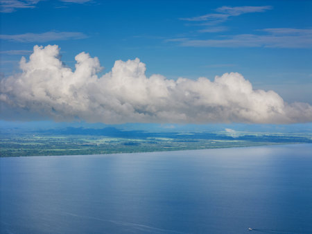 Big white cloud over shore land aerial drone viewの写真素材