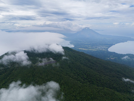 Lush green mountains and tranquil lakes visible under cloudy sky in Nicaragua natural landscape.の写真素材