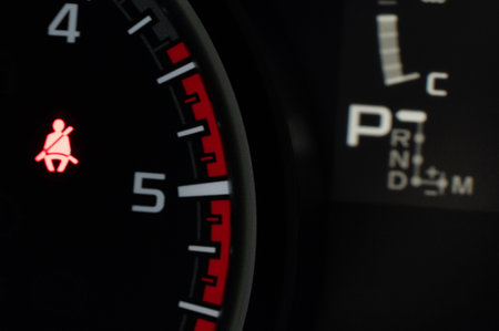 Red fasten seatbelt warning sign in car dashbaord close up viewの写真素材