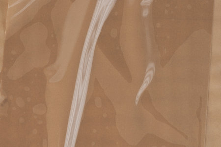 Wrinkled brown plastic tape with air bubbles close up viewの写真素材