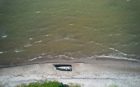 Old wooden small boat in coast aerial drone top viewの写真素材