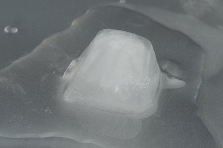 Melting ice cube in water macro close up viewの写真素材