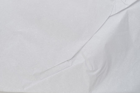 Surface of white paper with crump line above top close up viewの写真素材