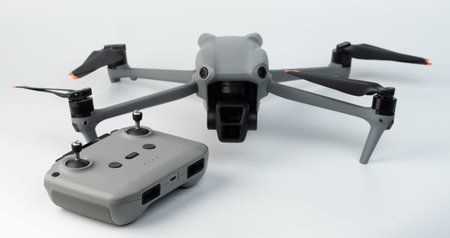 Quadcopter with remote control isolated on white studio background