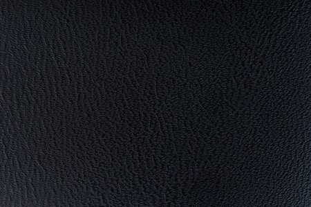 Close up of black color leather surface background with texture patternの写真素材