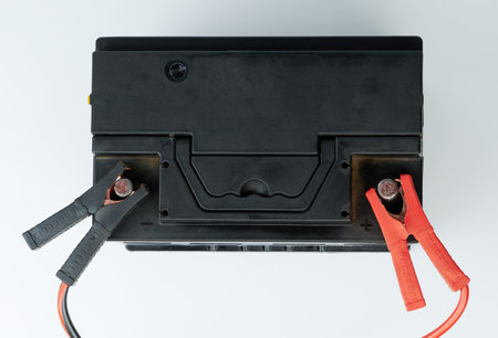 Auto battery maintenance service. Connected with wires accumulator isolated above top viewの写真素材