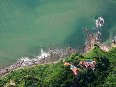 Villas roof with pool on green cliff in tropic sea background aerial drone viewの写真素材