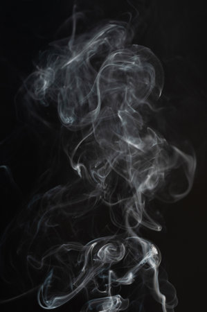 Smoky white cloud with transparent lines on black backgroundの写真素材