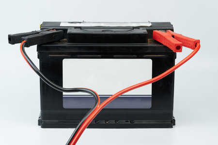 Auto car jumper cable connected front view isolated on studio backgroundの写真素材