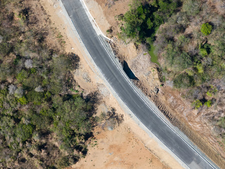 Erosion has caused significant damage to highway, creating hazardous conditions for drivers.の写真素材