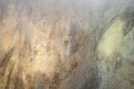 Brown and yellow rock stone on volcano crater backgroundの写真素材