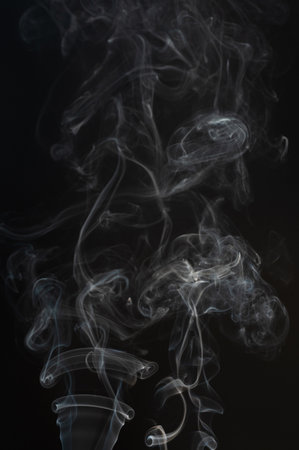Clean white smoke flow effect on black studio backgroundの写真素材