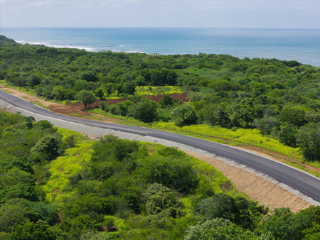 Curvy asphalt highway in sea coastline aerial drone viewの写真素材