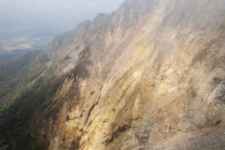 Volcano crater descent peak aerial drone view in smokeの写真素材