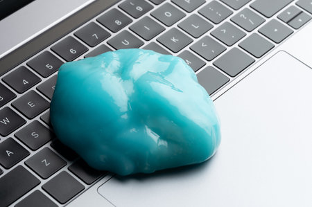 Blue gel slime compound on keyboard close up view