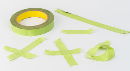 Pieces of green paper tape isolated on white studio backgroundの写真素材