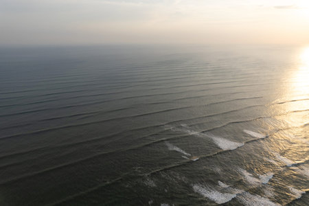 Calm ocean water seascape on sunset time aerial drone view