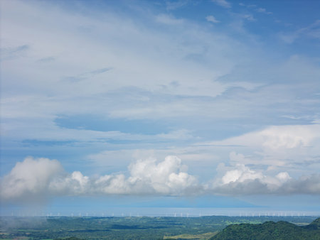 Wind turbine on green valley landscape aerial drone view