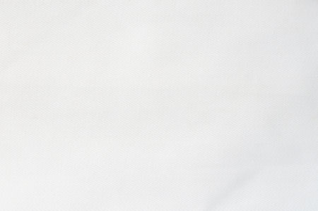 Close-up view of soft white fabric displaying smooth surface and even texture ideal for various design applications.の写真素材