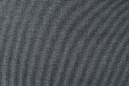 Detailed view of dark gray fabric with subtle texture that can enhance designs and textiles for various applications.の写真素材