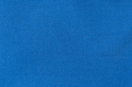 Close-up of vivid blue fabric showing its smooth texture, perfect for crafting and upholstery tasks.の写真素材