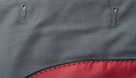 Textured fabric features visible stitching patterns and bold color contrast along the edge, highlighting craftsmanship.の写真素材