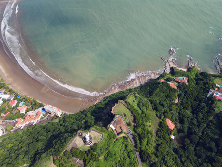 Green hill with jesus statue above top view with sea copy spaceの写真素材